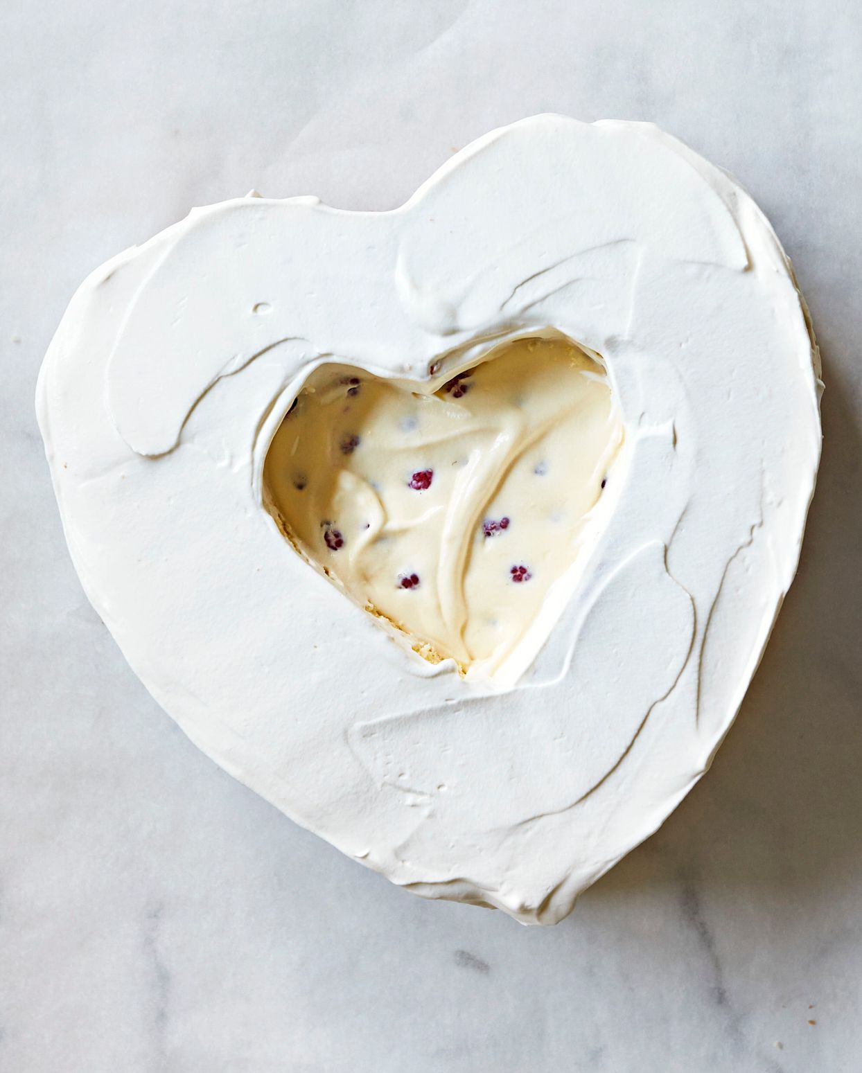 heart shaped cake layer with whipped frosting