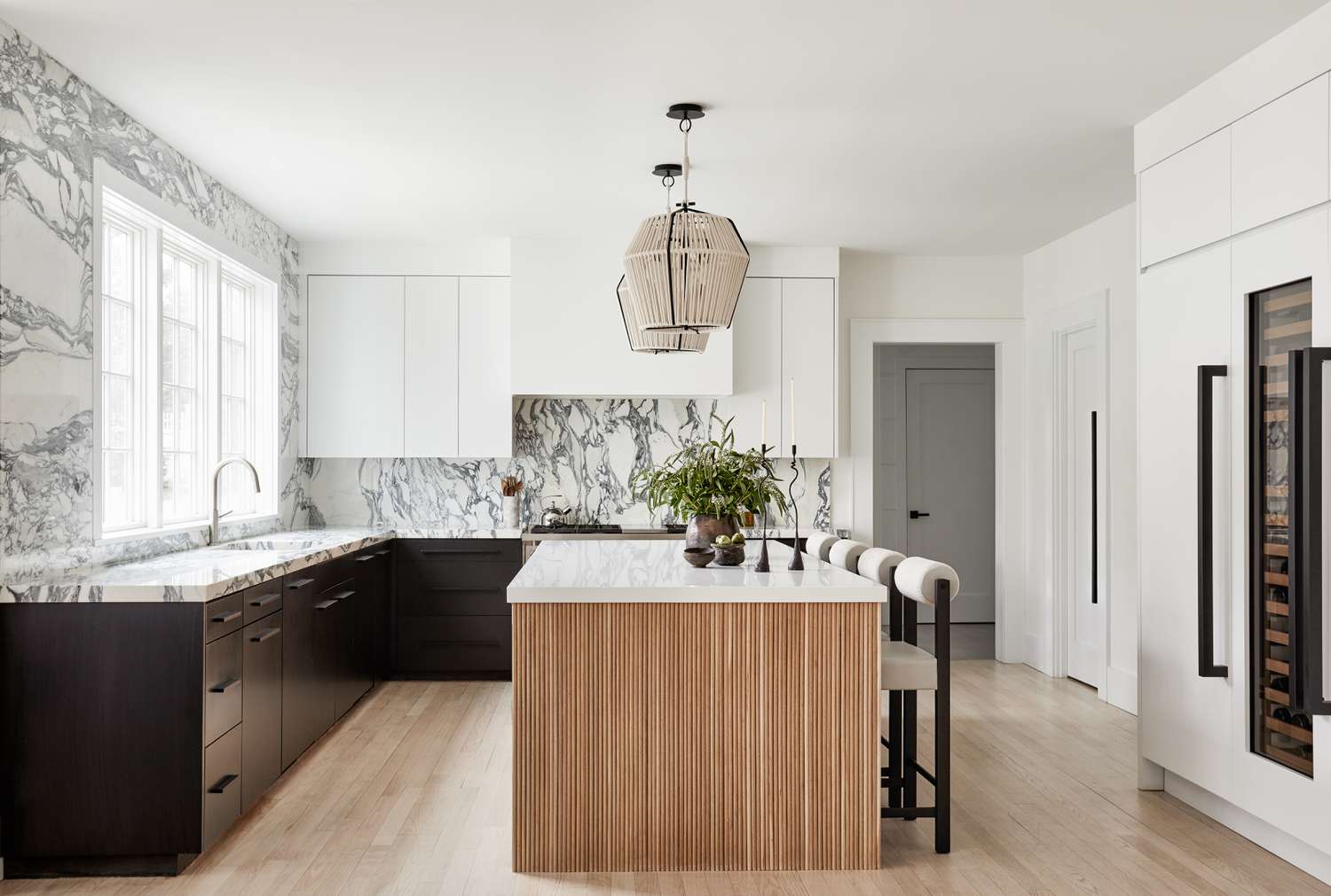 black cabinets with marble backsplash