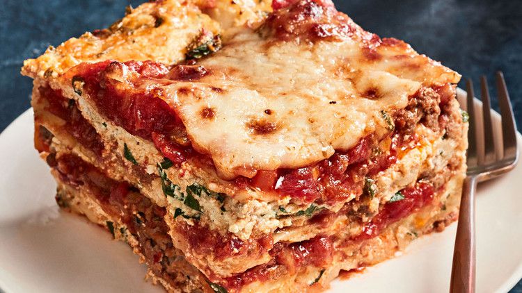 ultimate lasagna slice on plate with fork