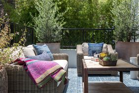 patio with wicker furniture and colorful throw pillows
