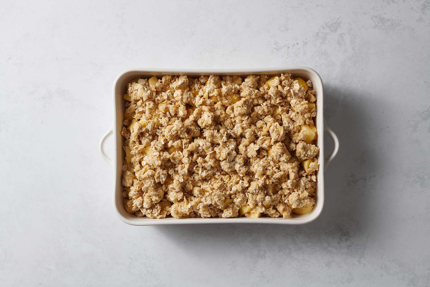 apple crisp assembled in baking dish