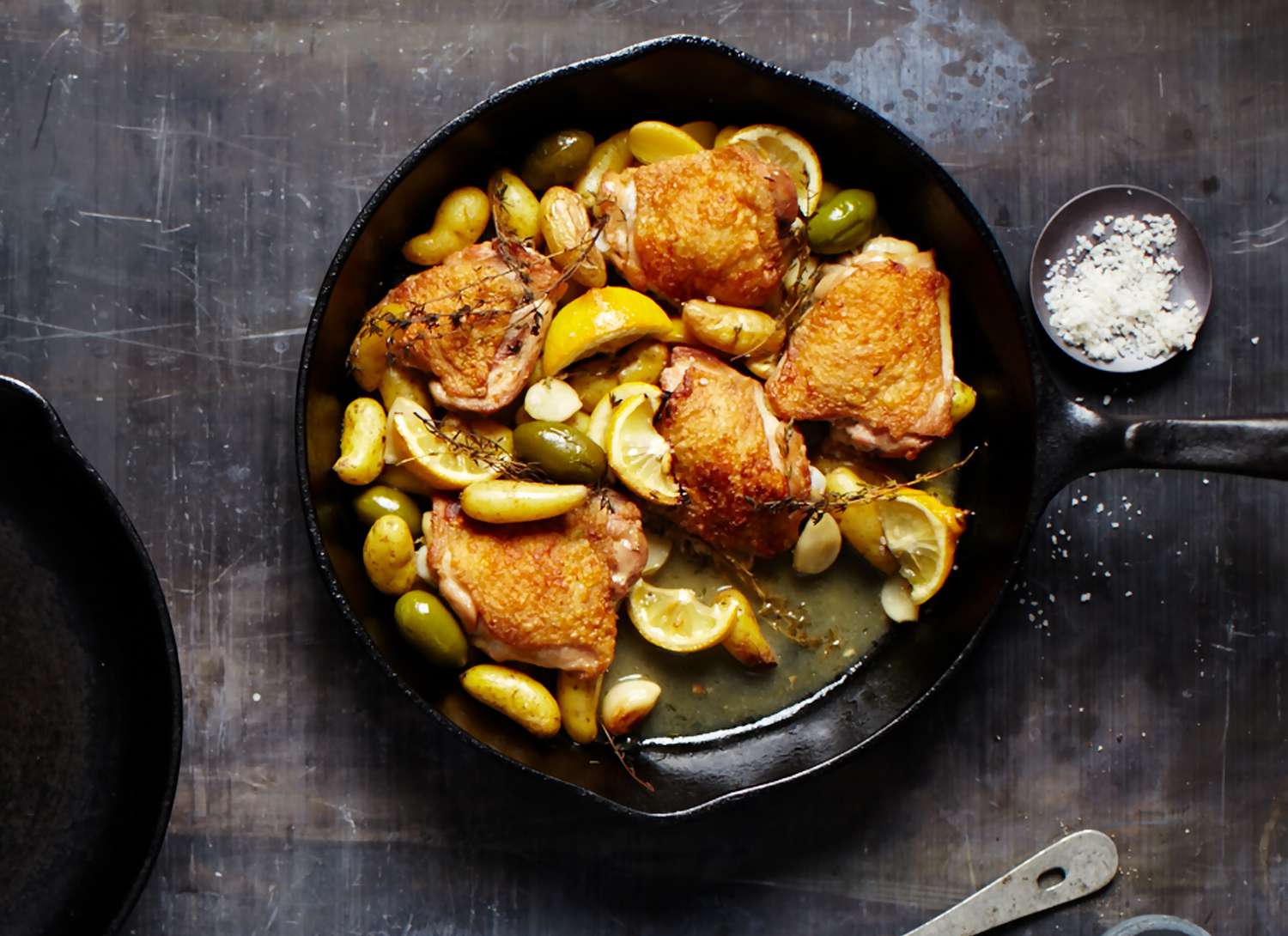 overhead view of lemon chicken skillet on a dark surface