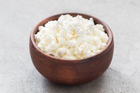 Bowl of cottage cheese on a gray surface