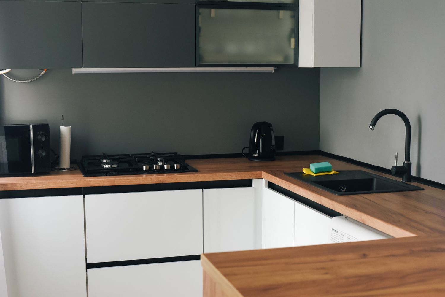 Modern kitchen with wooden countertops stove sink and appliances