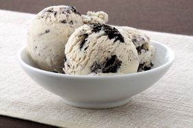 A bowl containing two scoops of cookies and cream ice cream