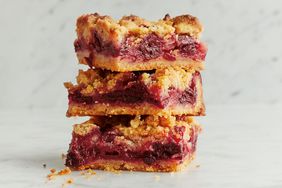 Stack of dessert bars with fruit filling and crumbly topping