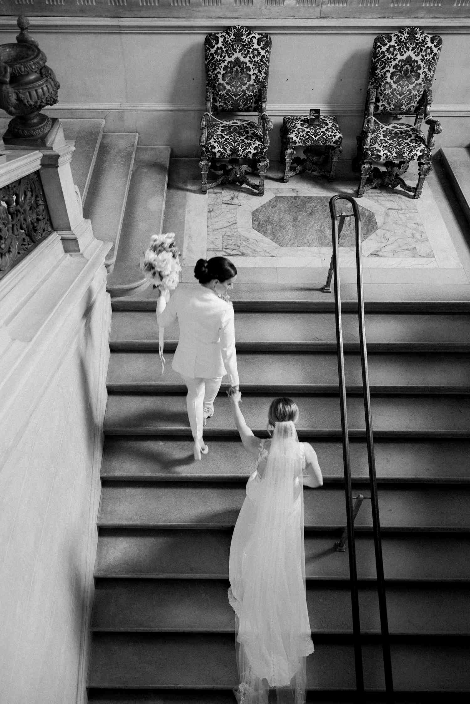 Black and white photo of brides on staircase