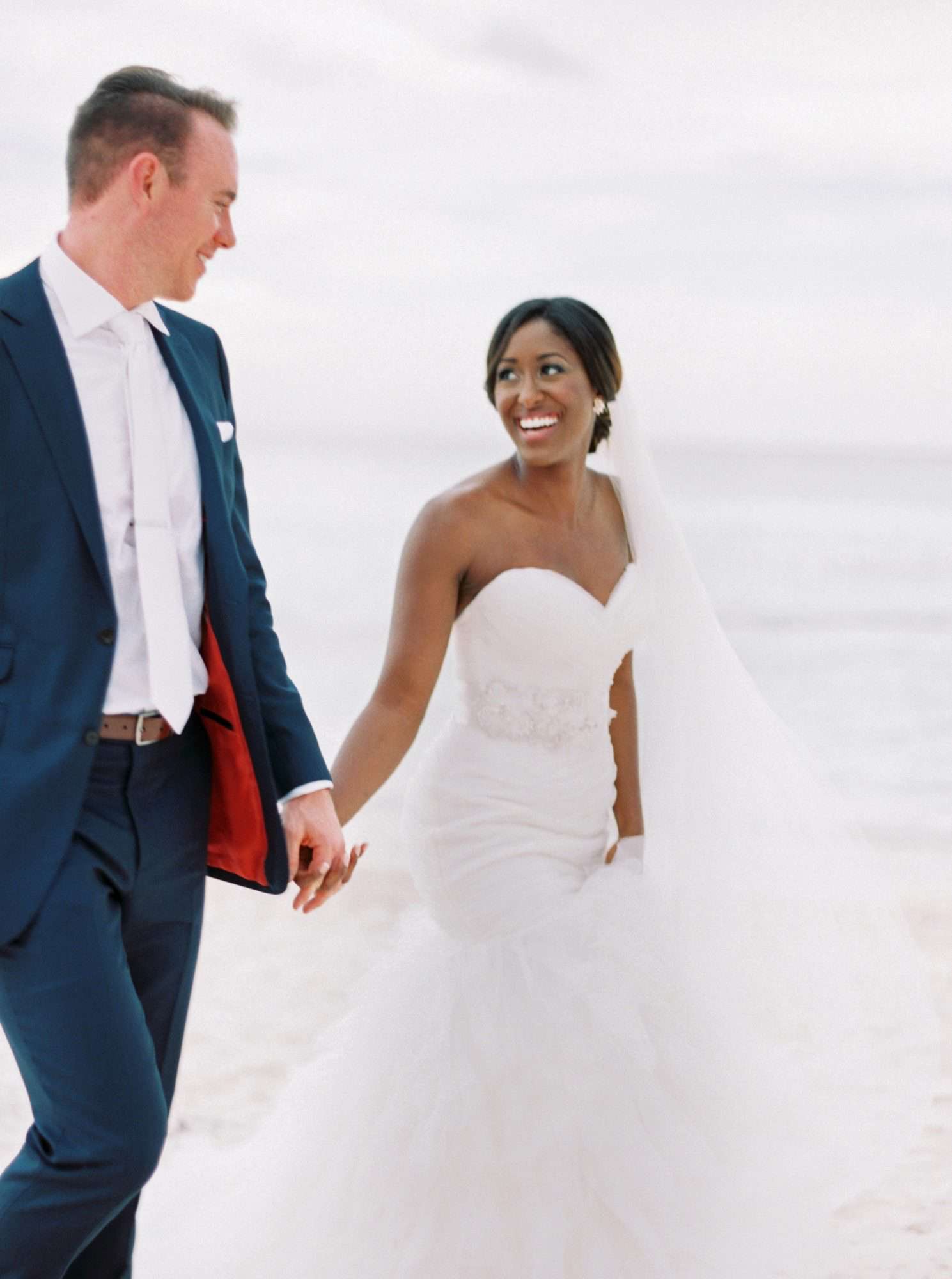 beach wedding dresses bride and groom holding hands