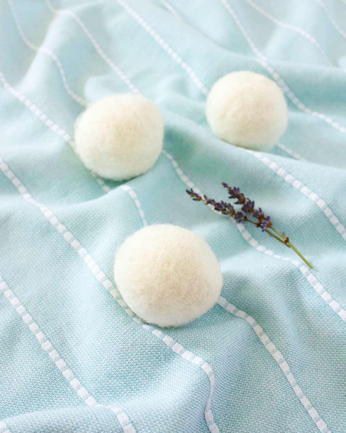 Three wool dryer balls on a blanket