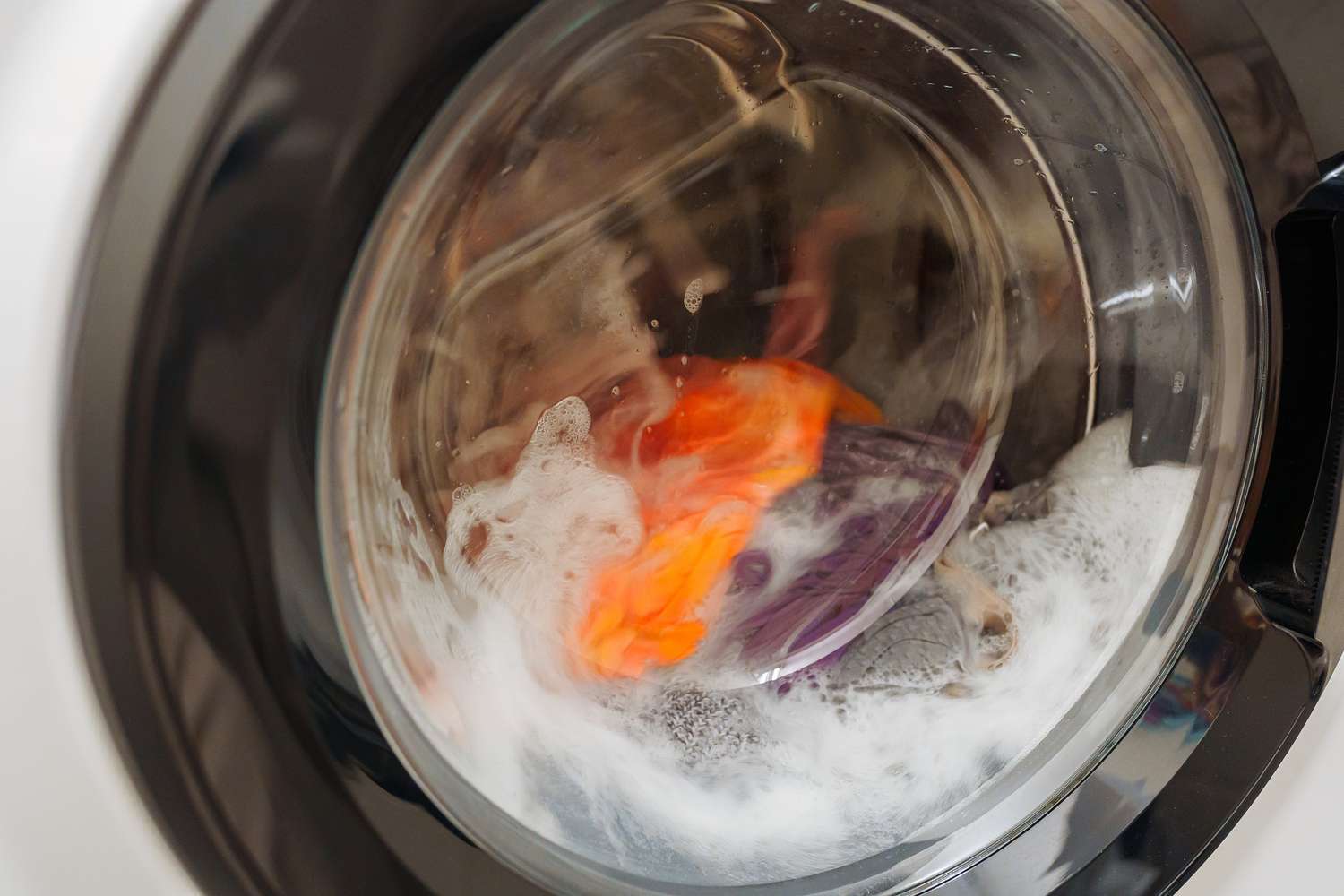 Closeup of laundry inside a washing machine during a washing cycle