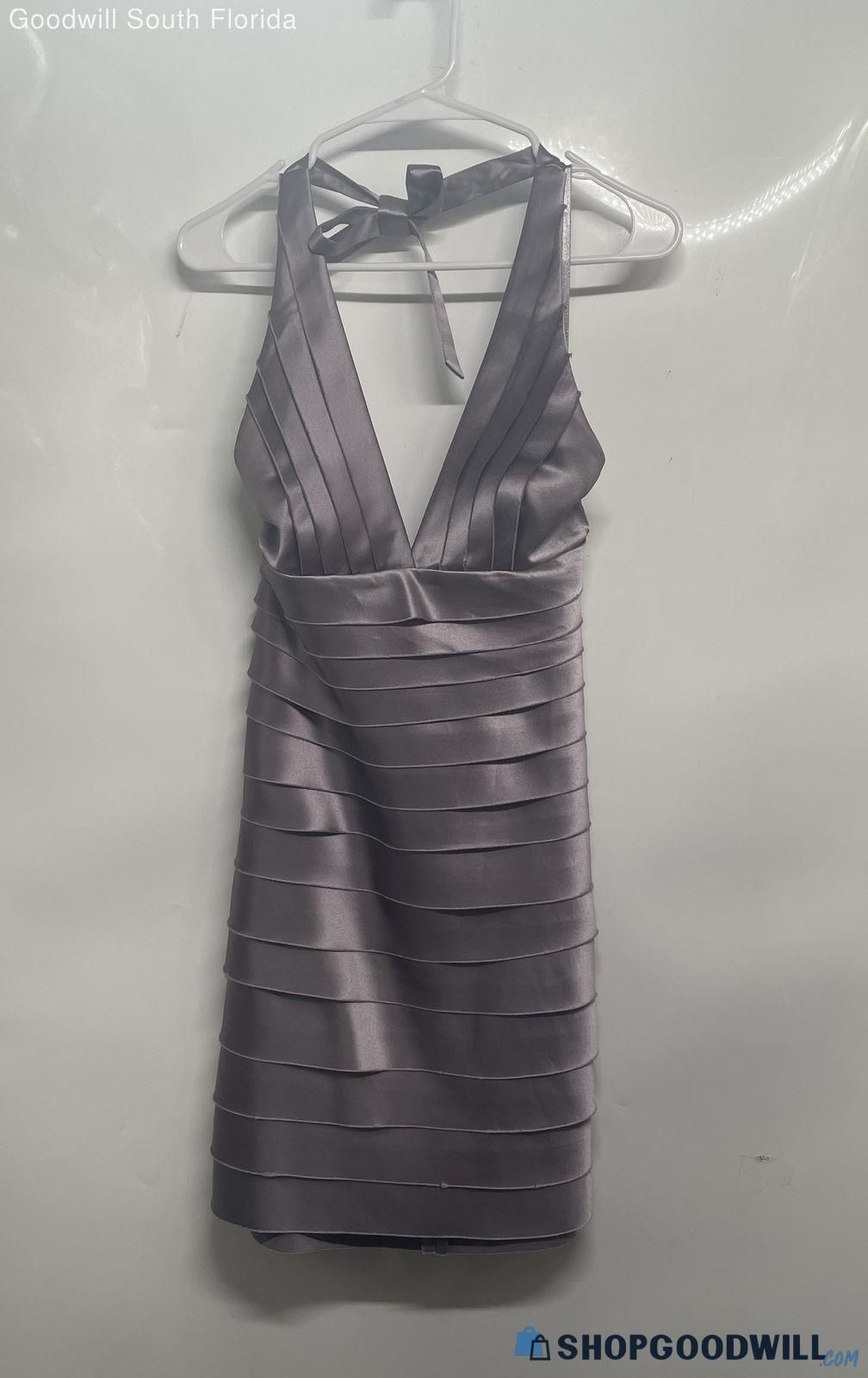A sleeveless bandagestyle dress hanging on a hanger