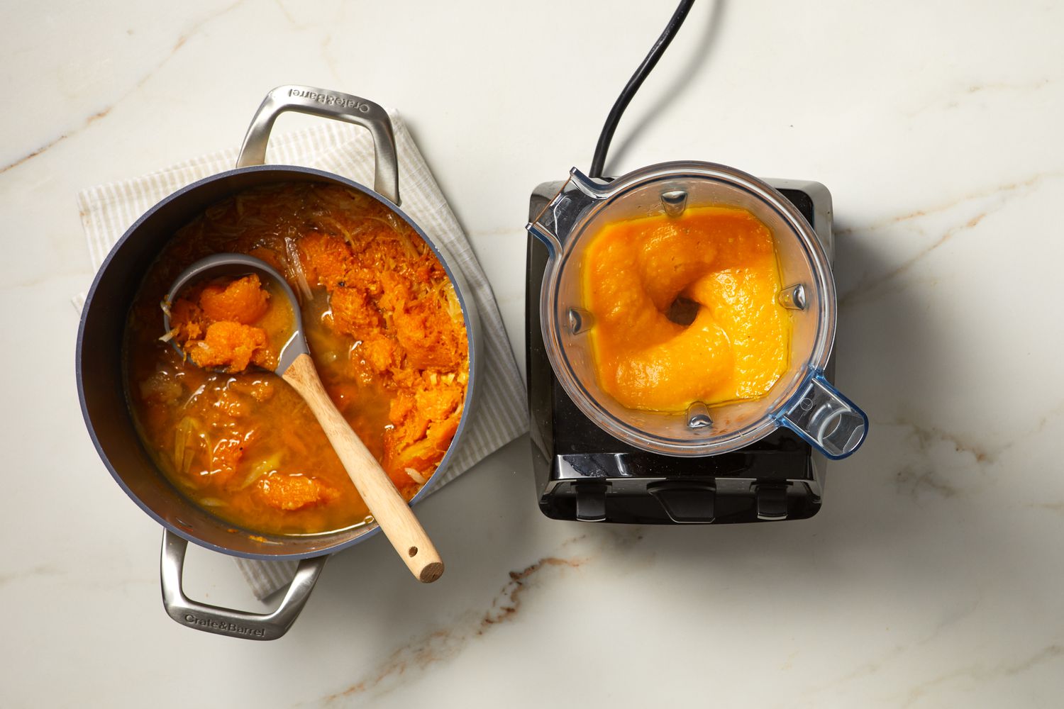 pot of soup next to blender with puree
