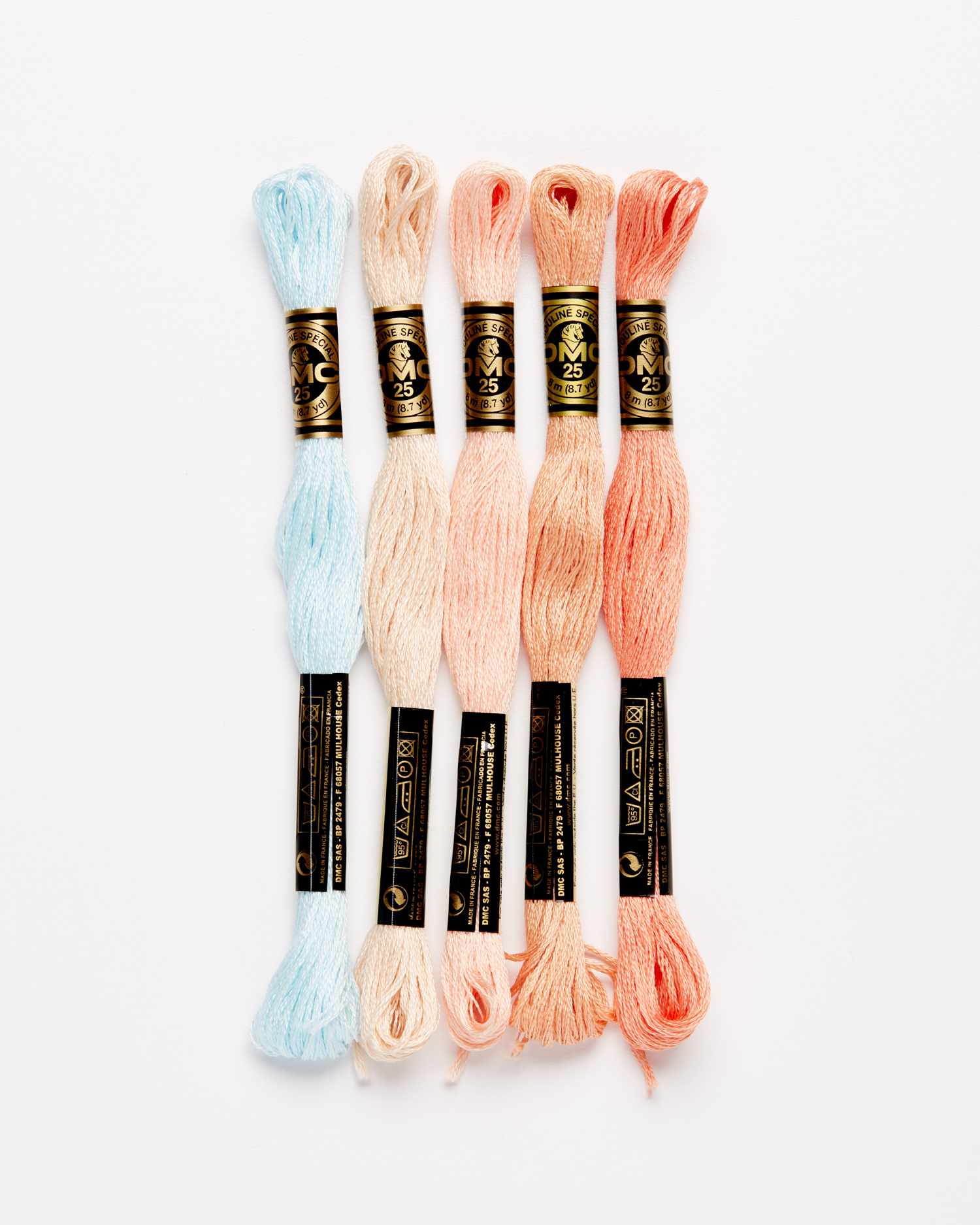 blue and pink embroidery floss against a white background