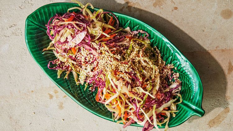 shredded cabbage with ginger vinaigrette topped with sesame seeds