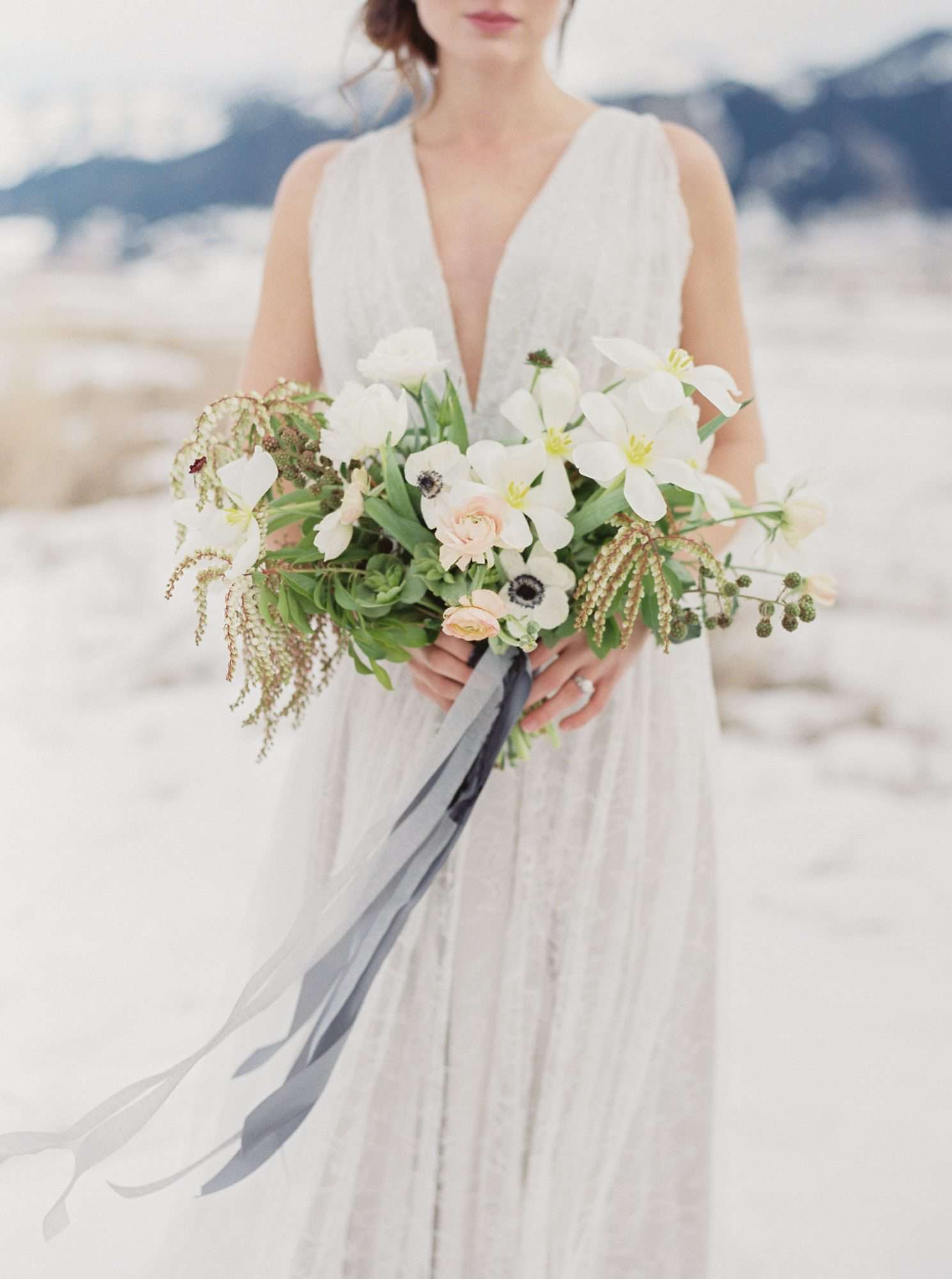 bride holding white bouquet