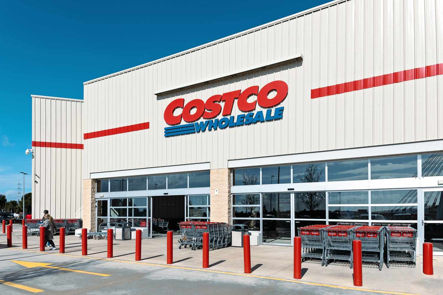 Facade of a Costco Wholesale store with shopping carts in foreground