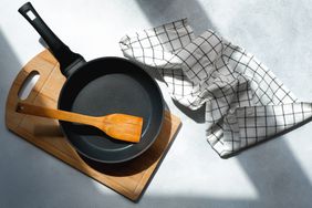 Clean cast iron skillet next to kitchen towel
