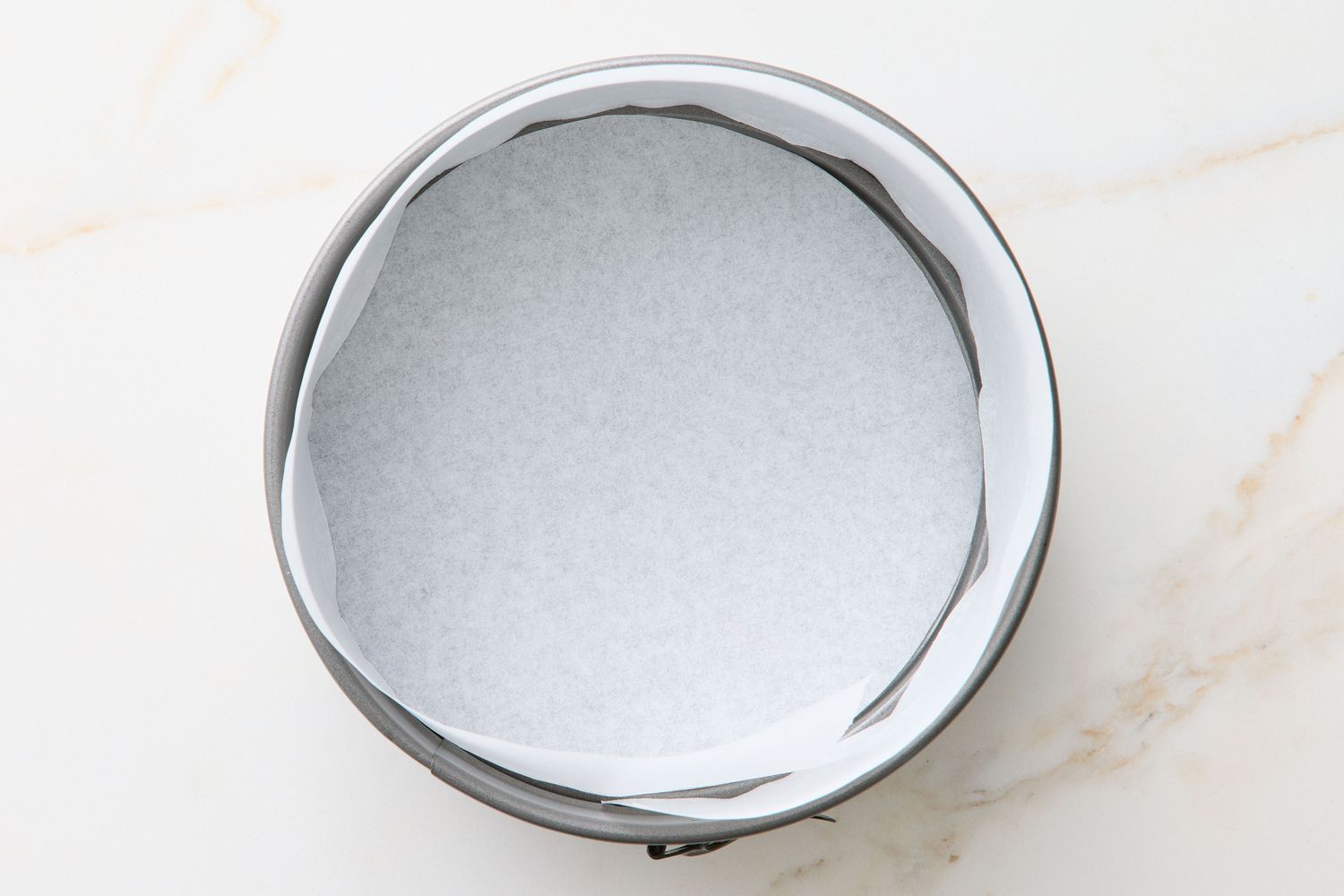 A springform pan lined with parchment paper