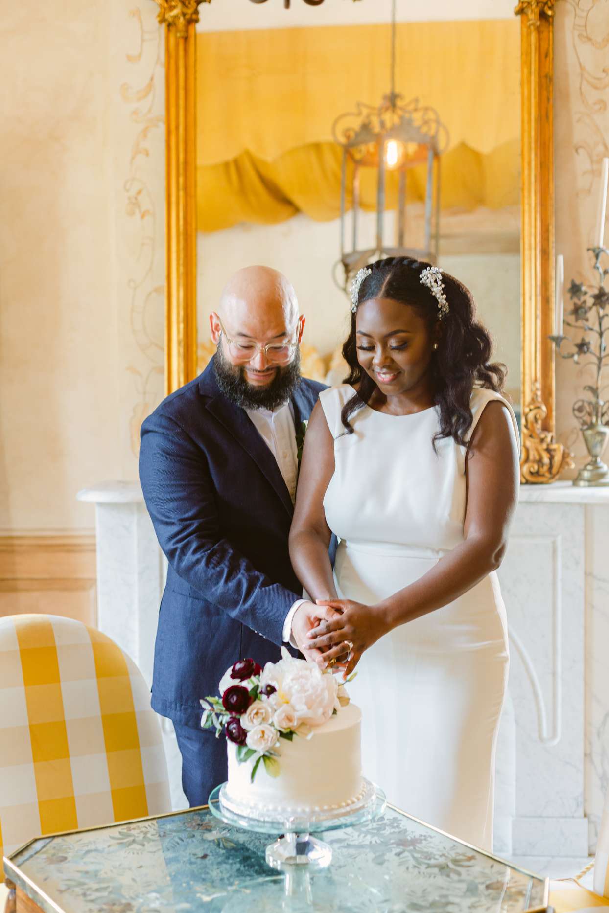 bride and groom cutting small cake together