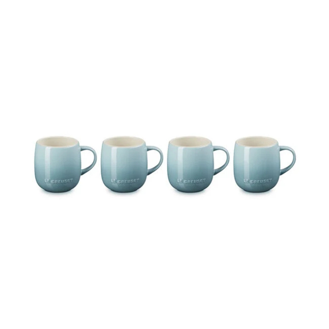Four ceramic mugs arranged in a row each with a smooth rounded design