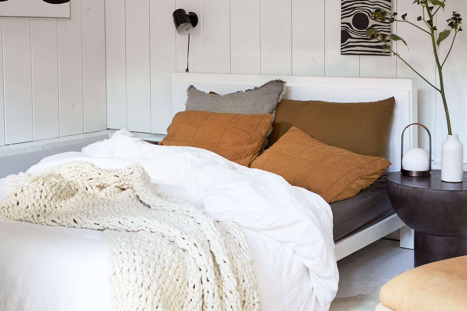 Bed with autumn toned bedding