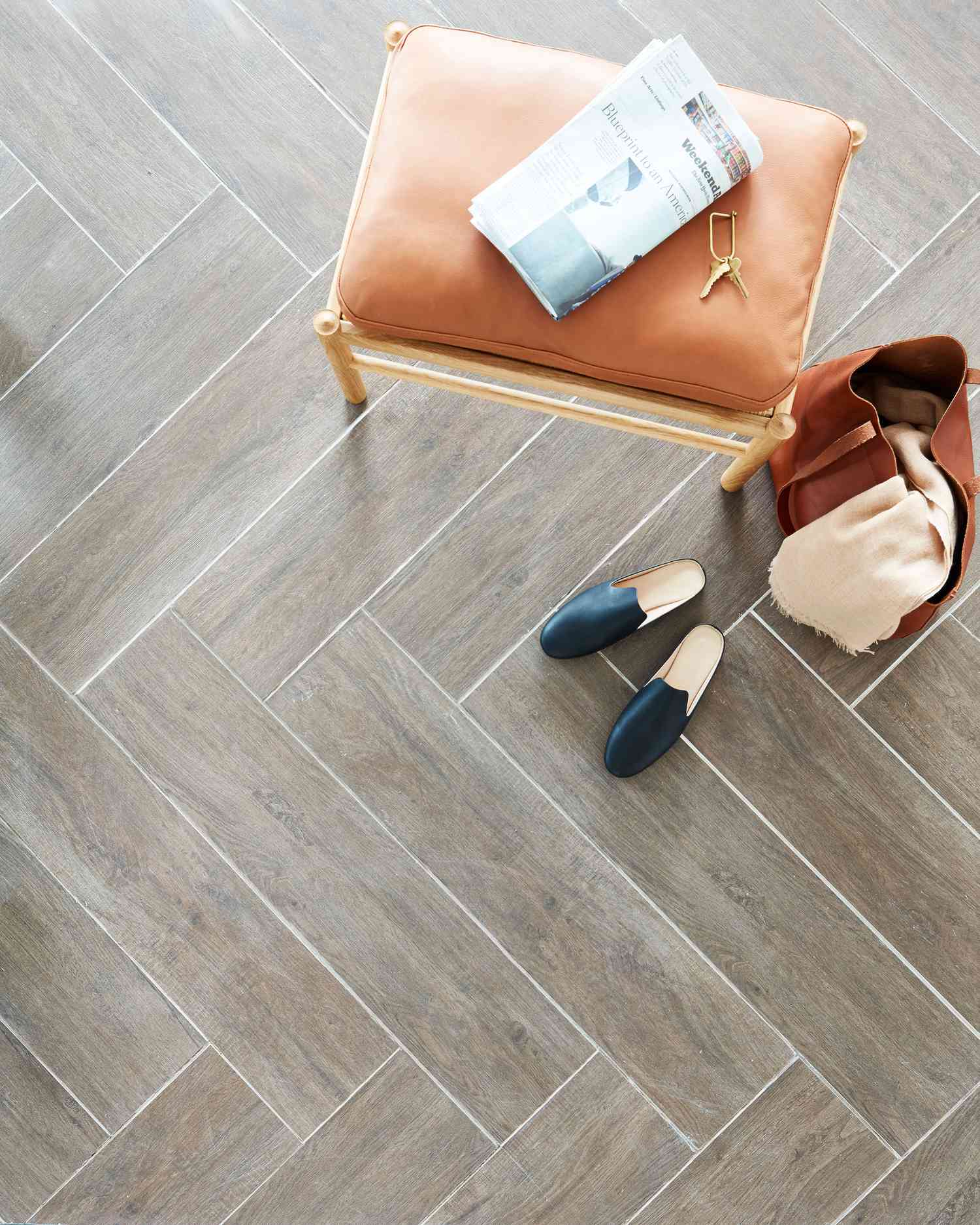 herringbone tile that looks like wood with bench, bag and shoes