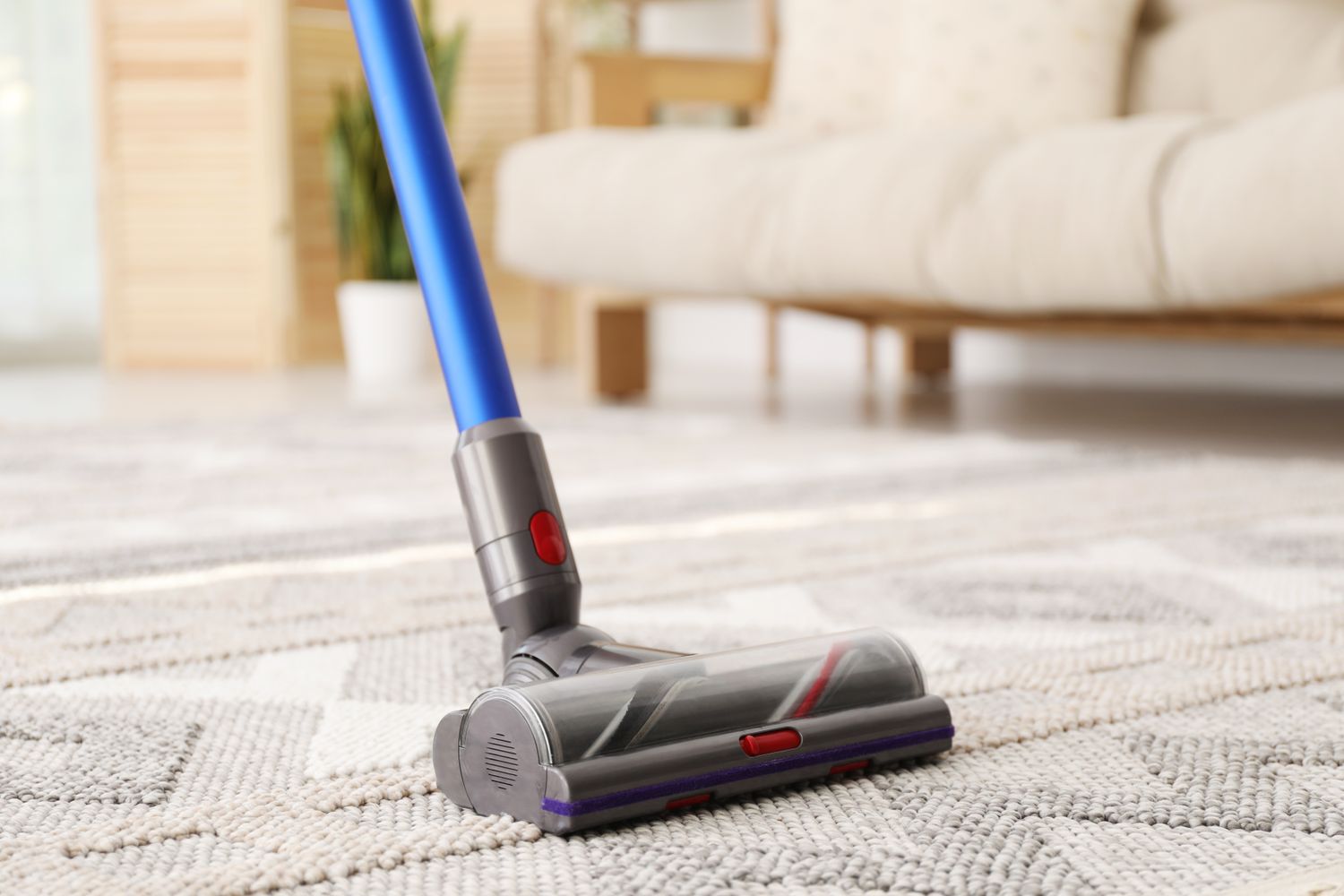 Cleaning with wireless handheld vacuum cleaner indoors, closeup
