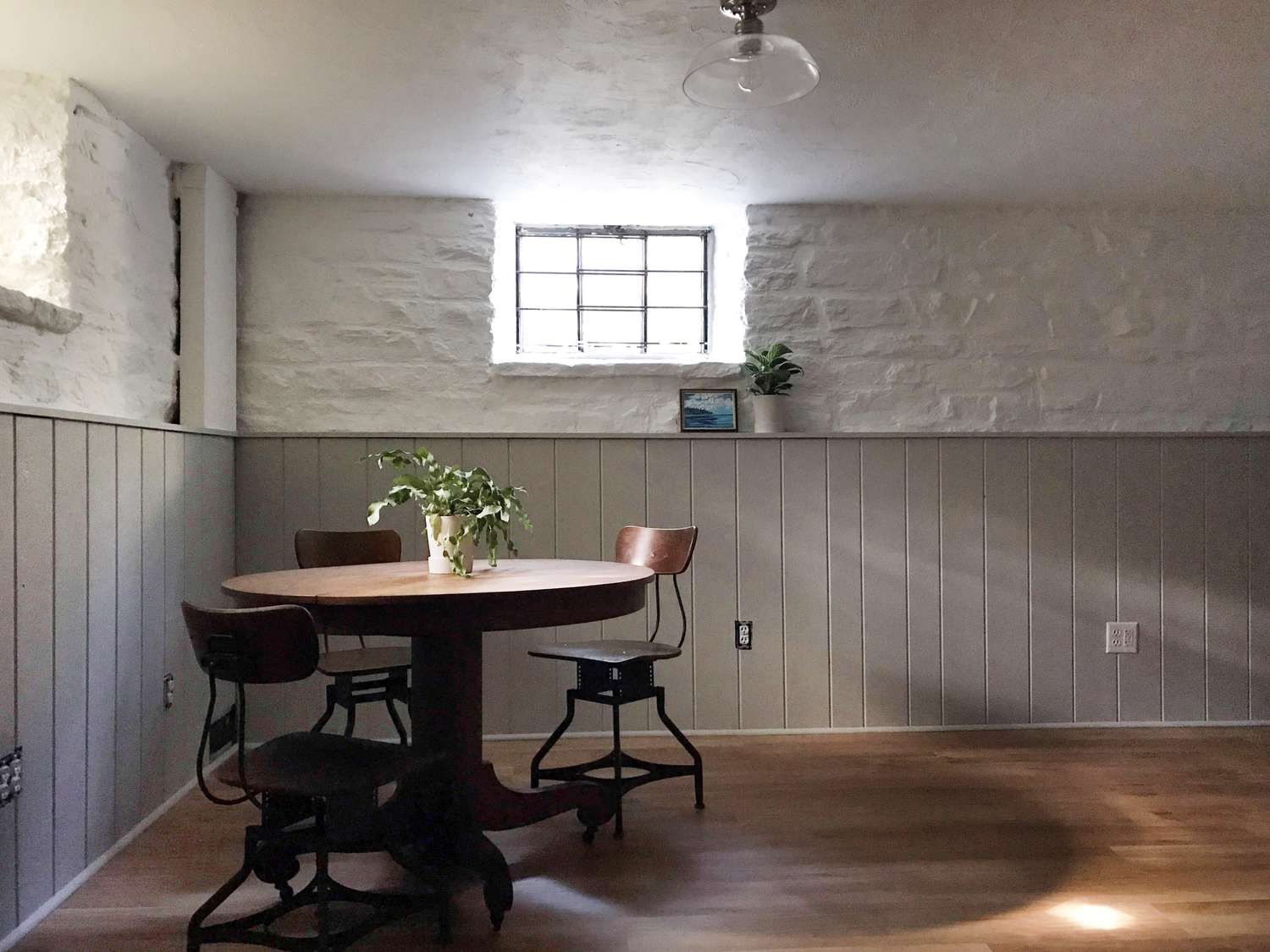Gray basement with wood table and chairs