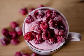 Frozen raspberries on top of a smoothie