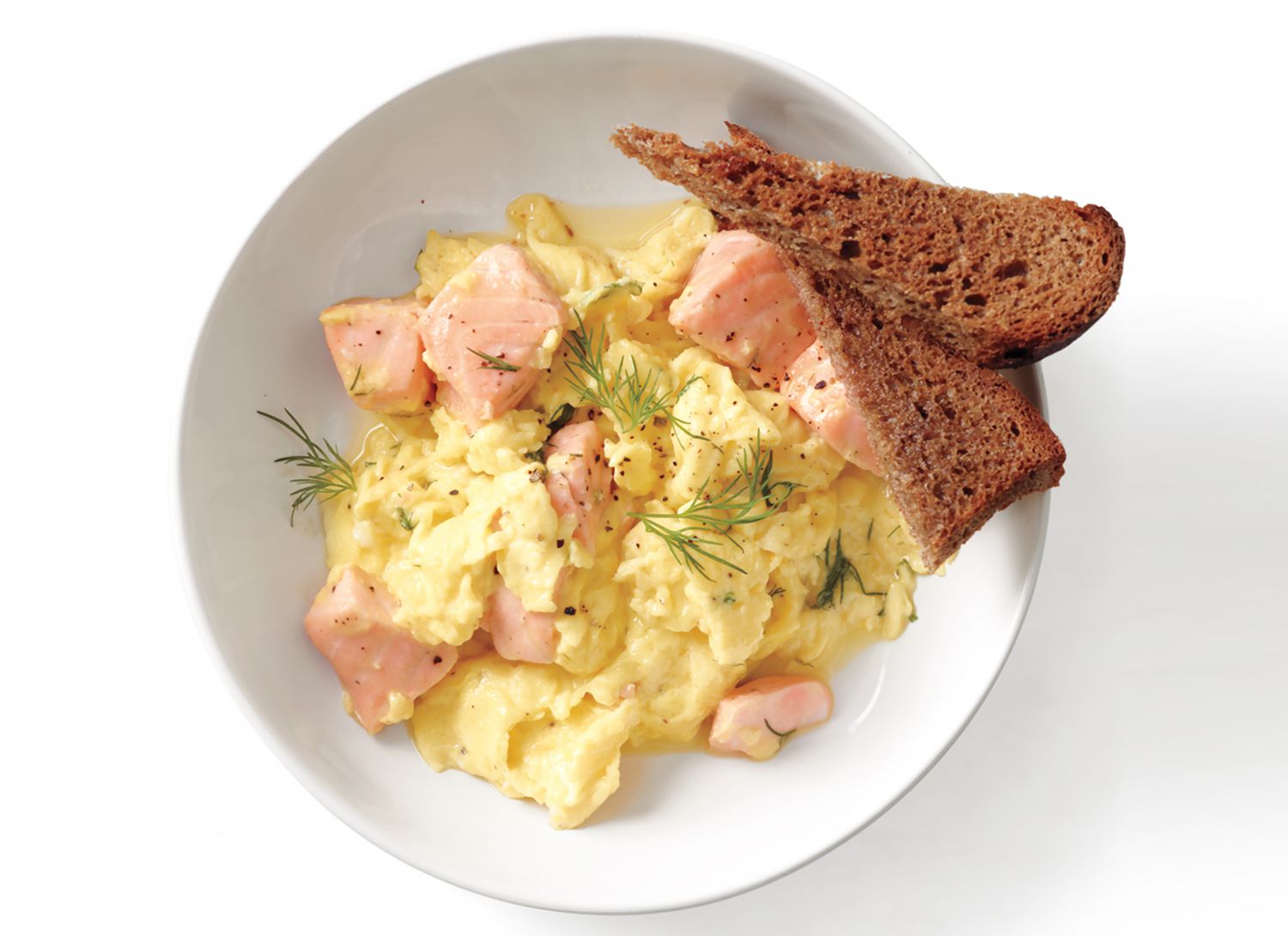 overhead view of salmon and scrambled eggs with toast