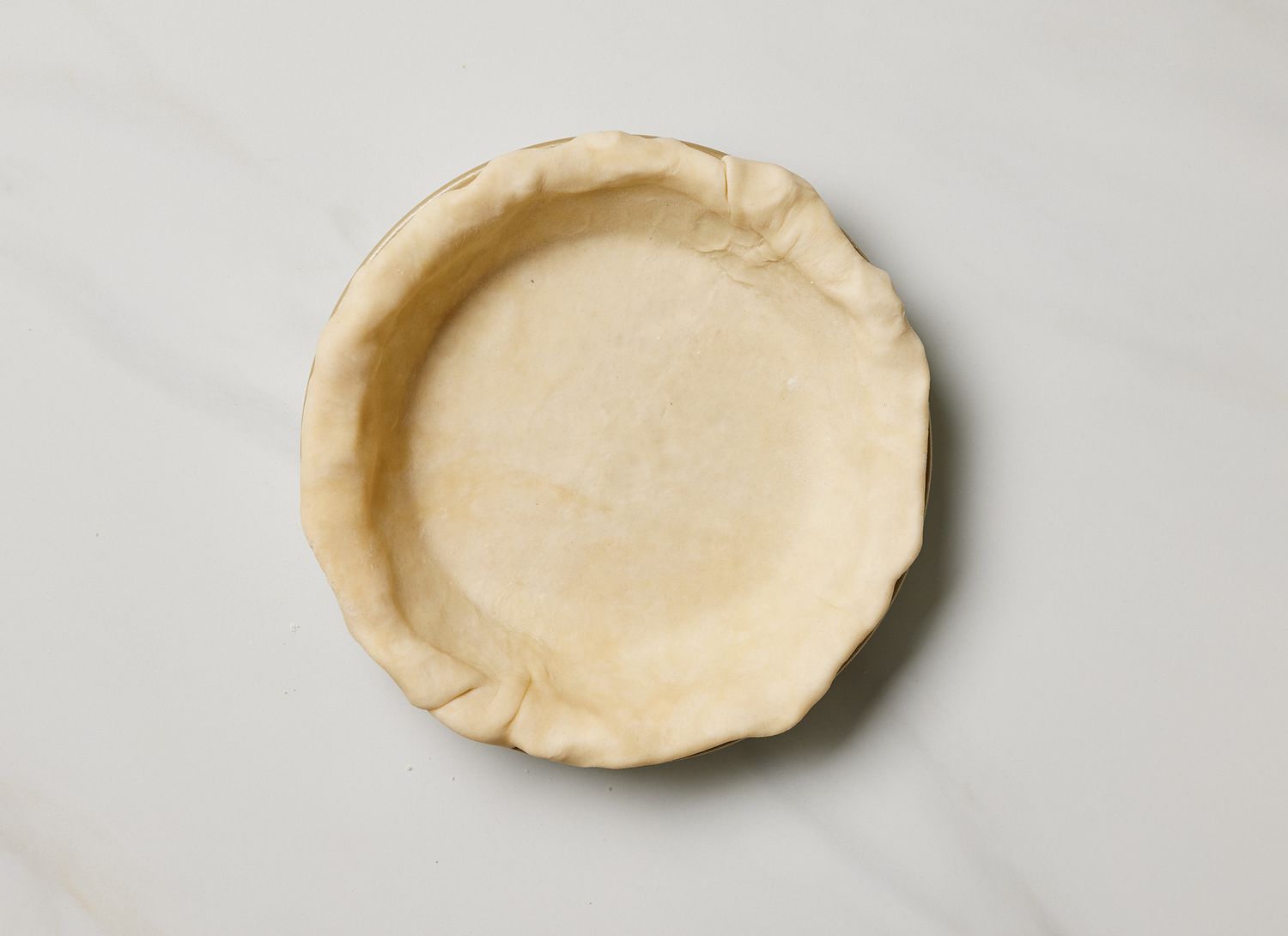 overhead view of pie crust in a pie pan