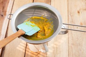 puree fruit in metal sieve