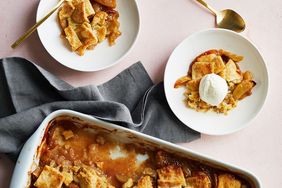 A freshly baked apple pandowdy in a baking dish with two servings plated one topped with ice cream