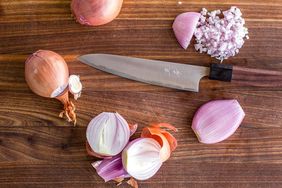who and minced shallots on cutting board with knife