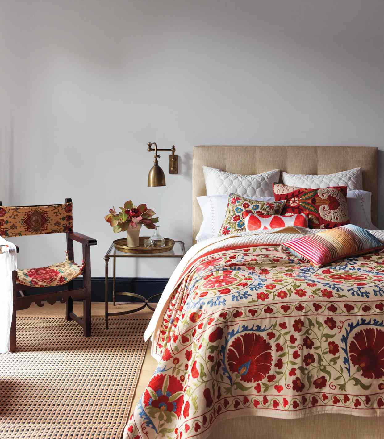 red and blue floral patterned textiles in bedroom