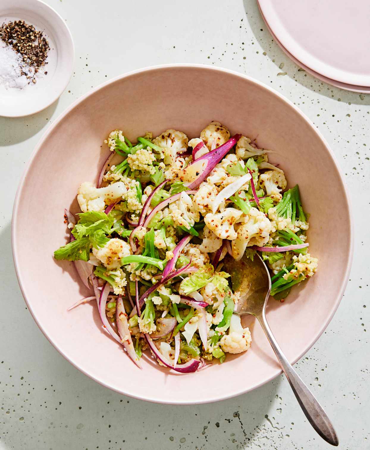 cauliflower faux-tato salad served in a pink bowl