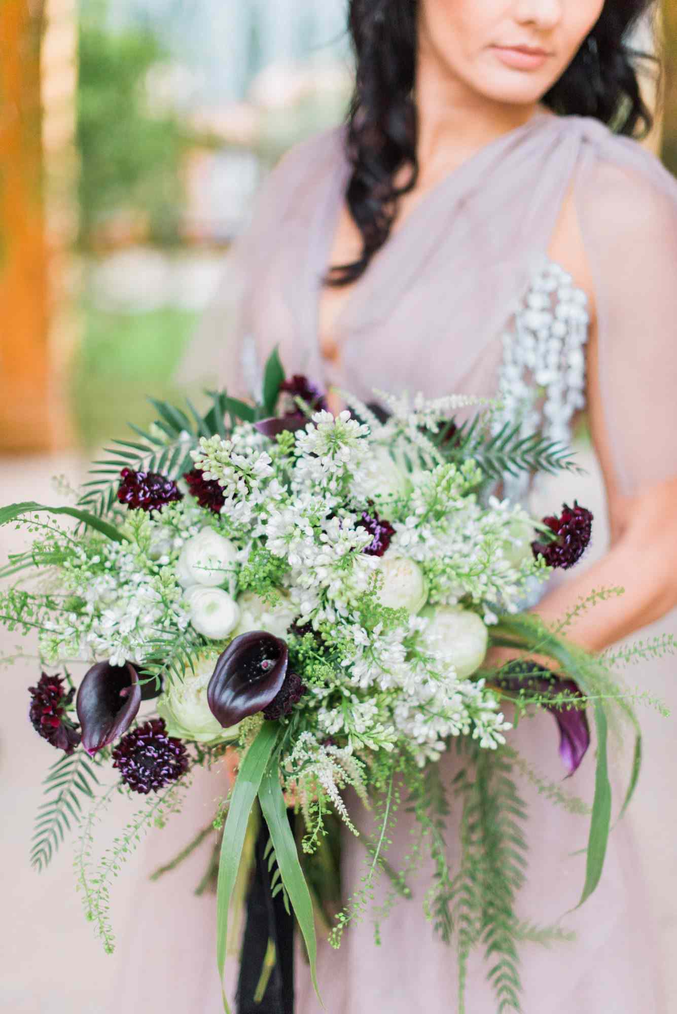 bouquet with purple calla lilies greenery and white flowers