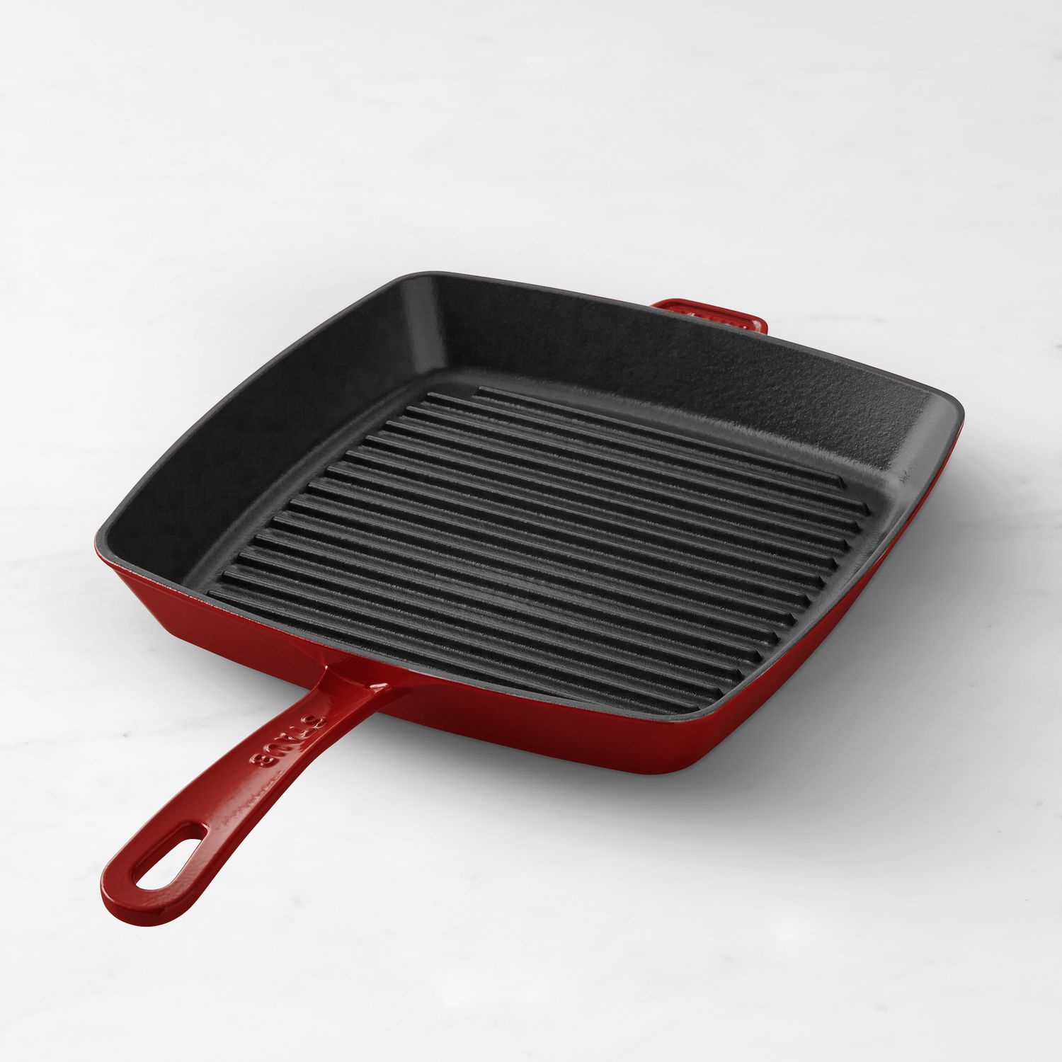 Square grill pan with ridged cooking surface and a handle
