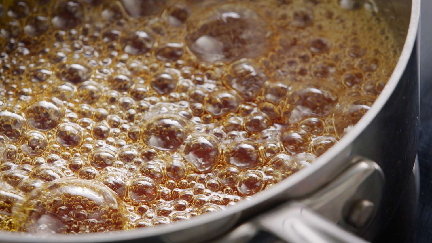 sugar syrup cooking in pan for peanut brittle