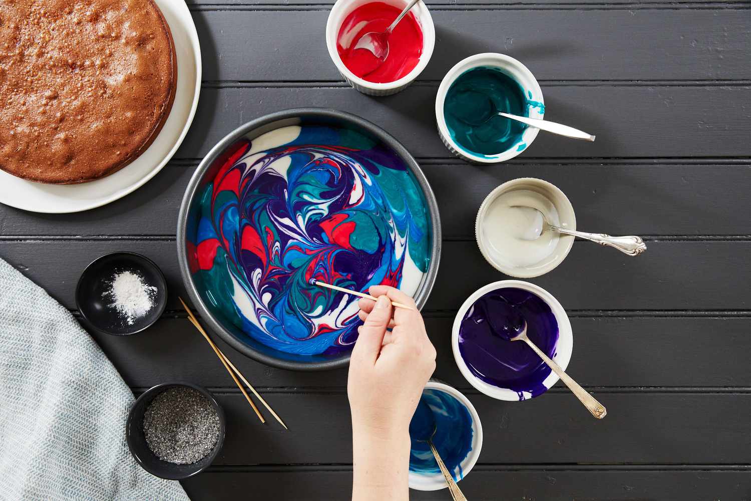 galaxy cake swirling frosting with toothpick