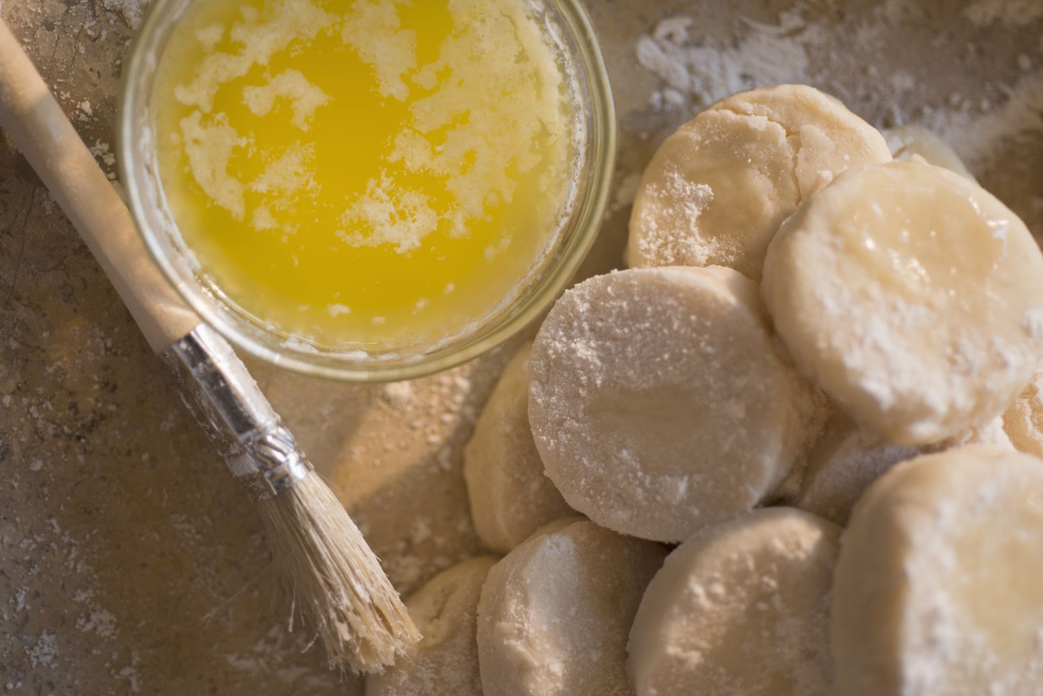 basting brush next to biscuits and melted butter