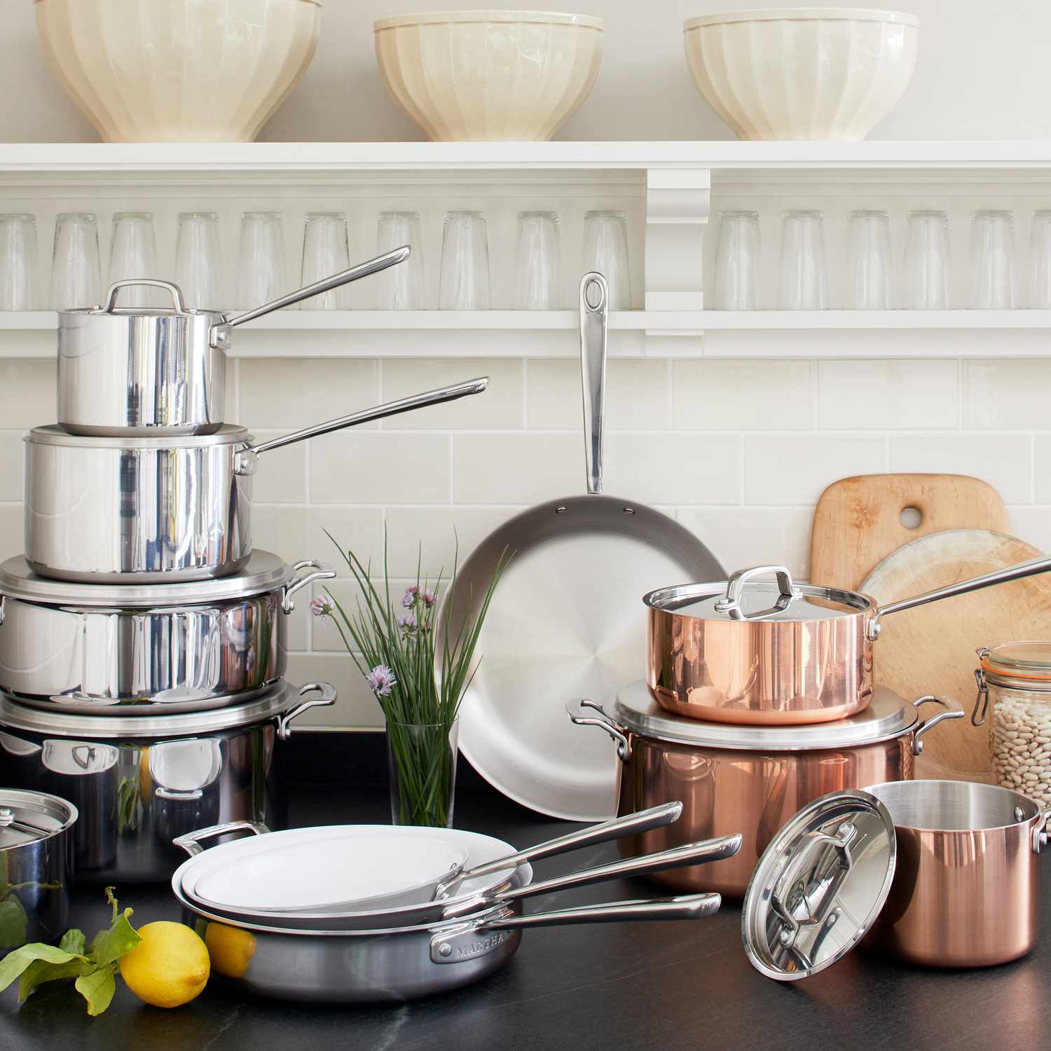 multiple pieces of cookware in a white kitchen