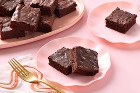 Plates with chewy brownies served on them accompanied by a napkin and fork