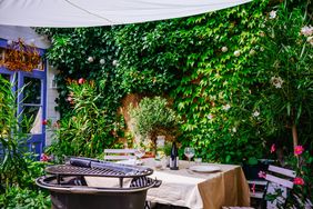 Barbeque cast iron grill and table ready for eating on terrace at home.