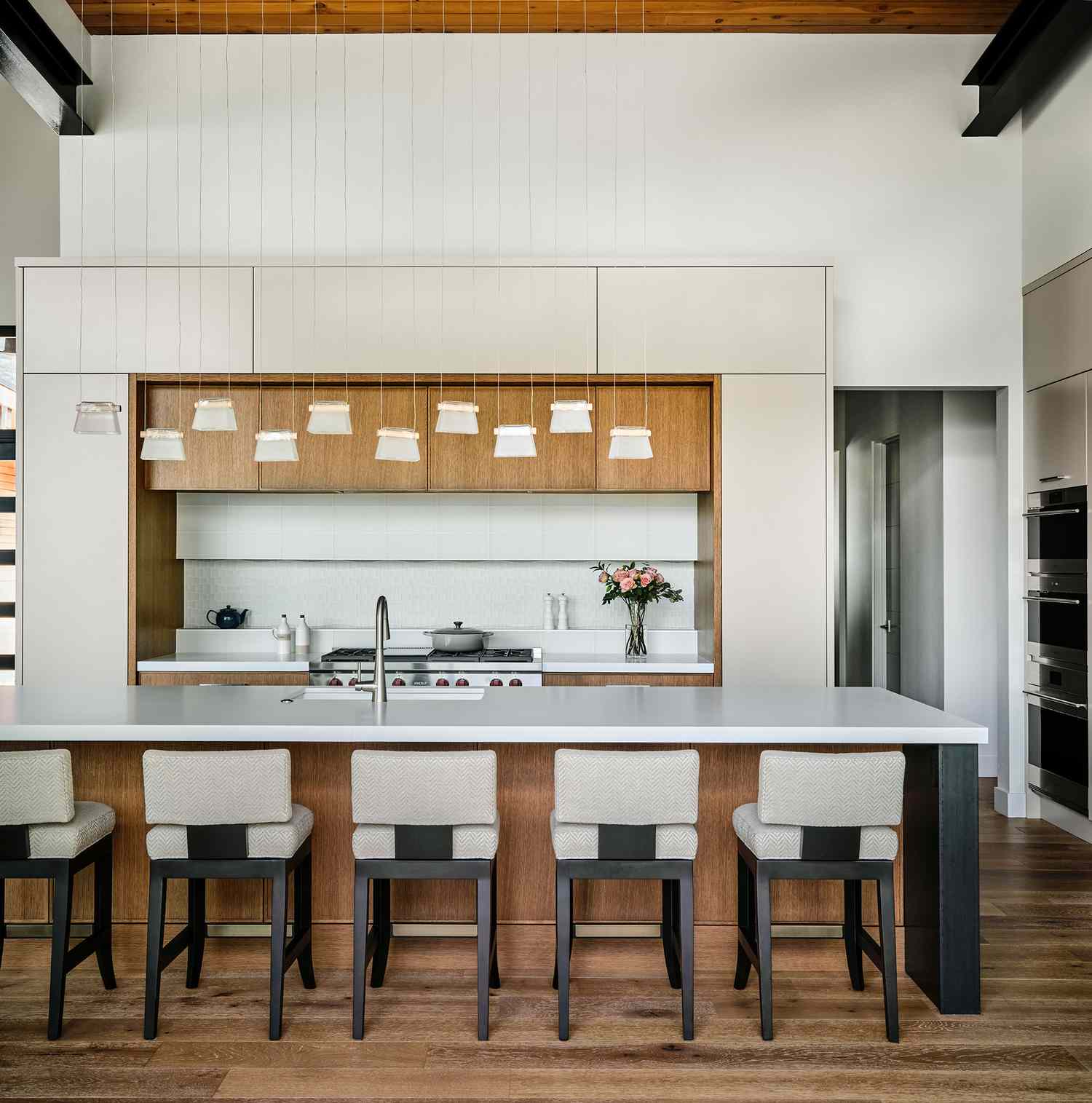 a white kitchen with wood accents