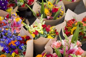 Bouquets of assorted flowers wrapped in brown paper arrangement