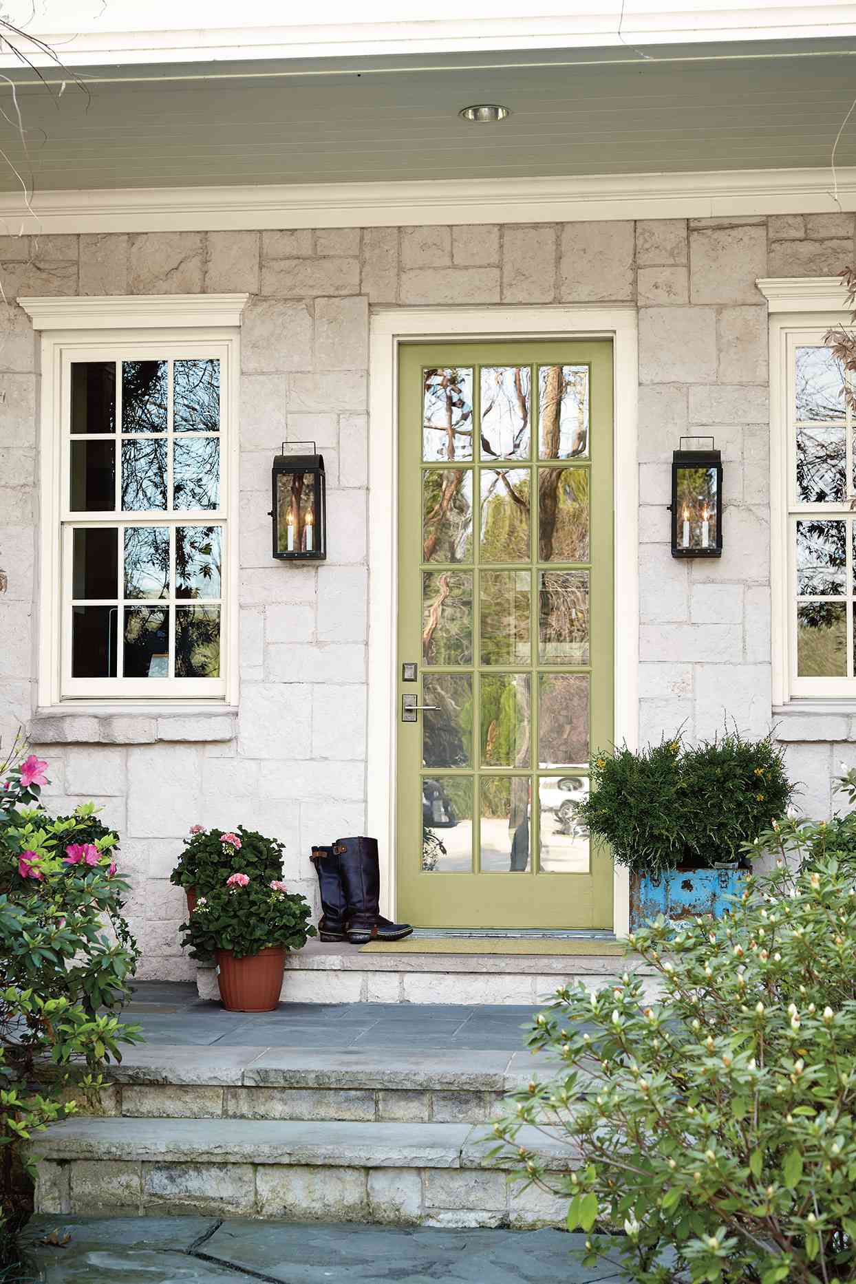 sage green front door with stone steps entrance way