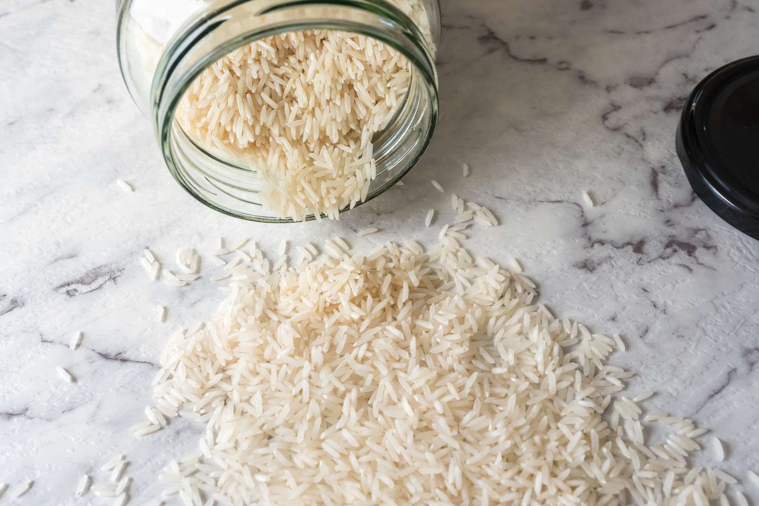 white rice in jar and on counter