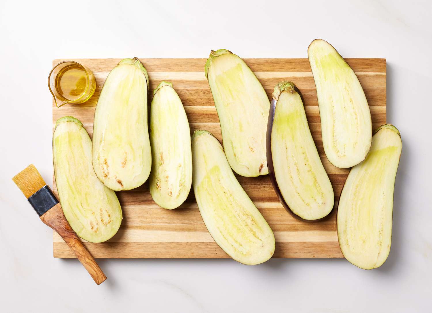 overhead view of sliced eggplant on a cutting board
