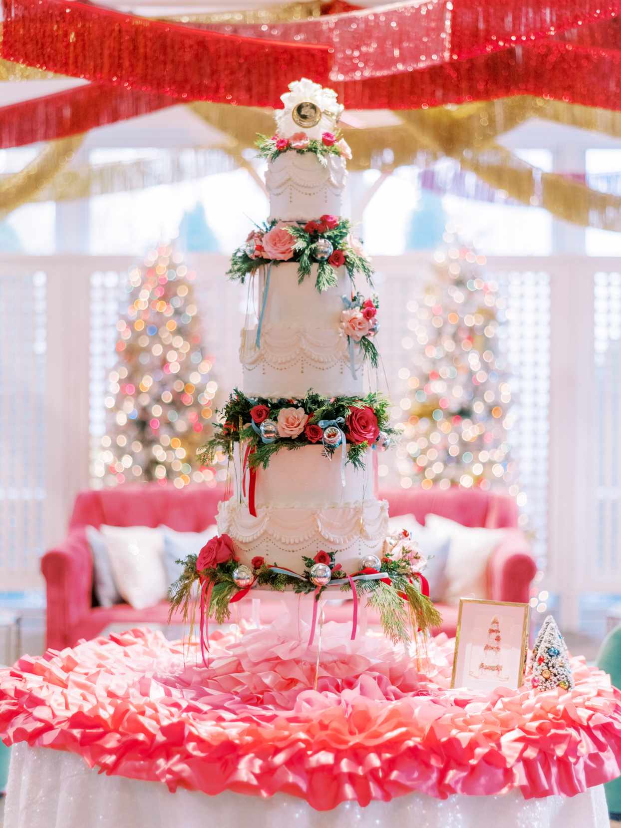 classic wedding cake decorated with garland and christmas ornaments